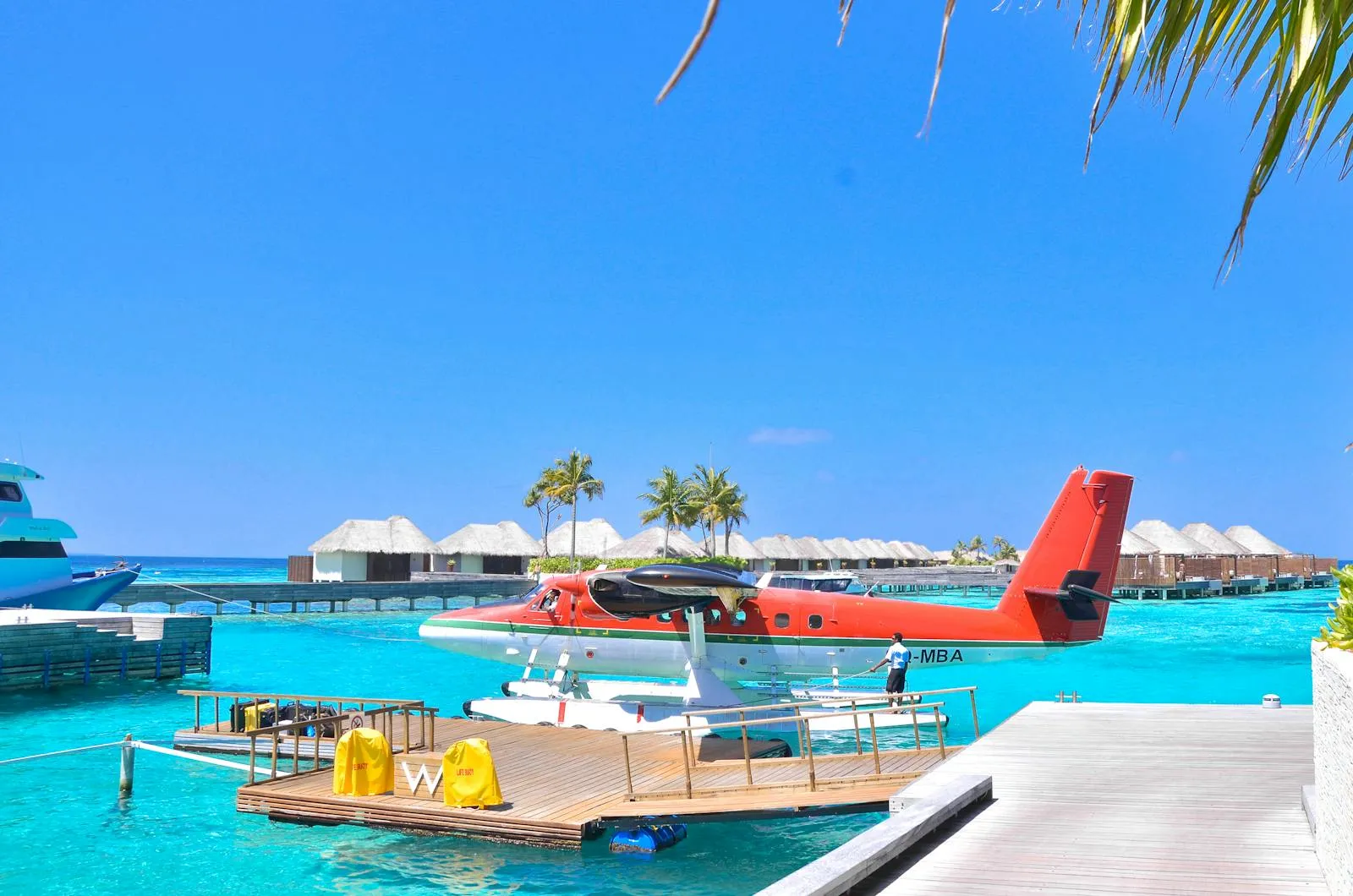 A red seaplane at a Maldives dock