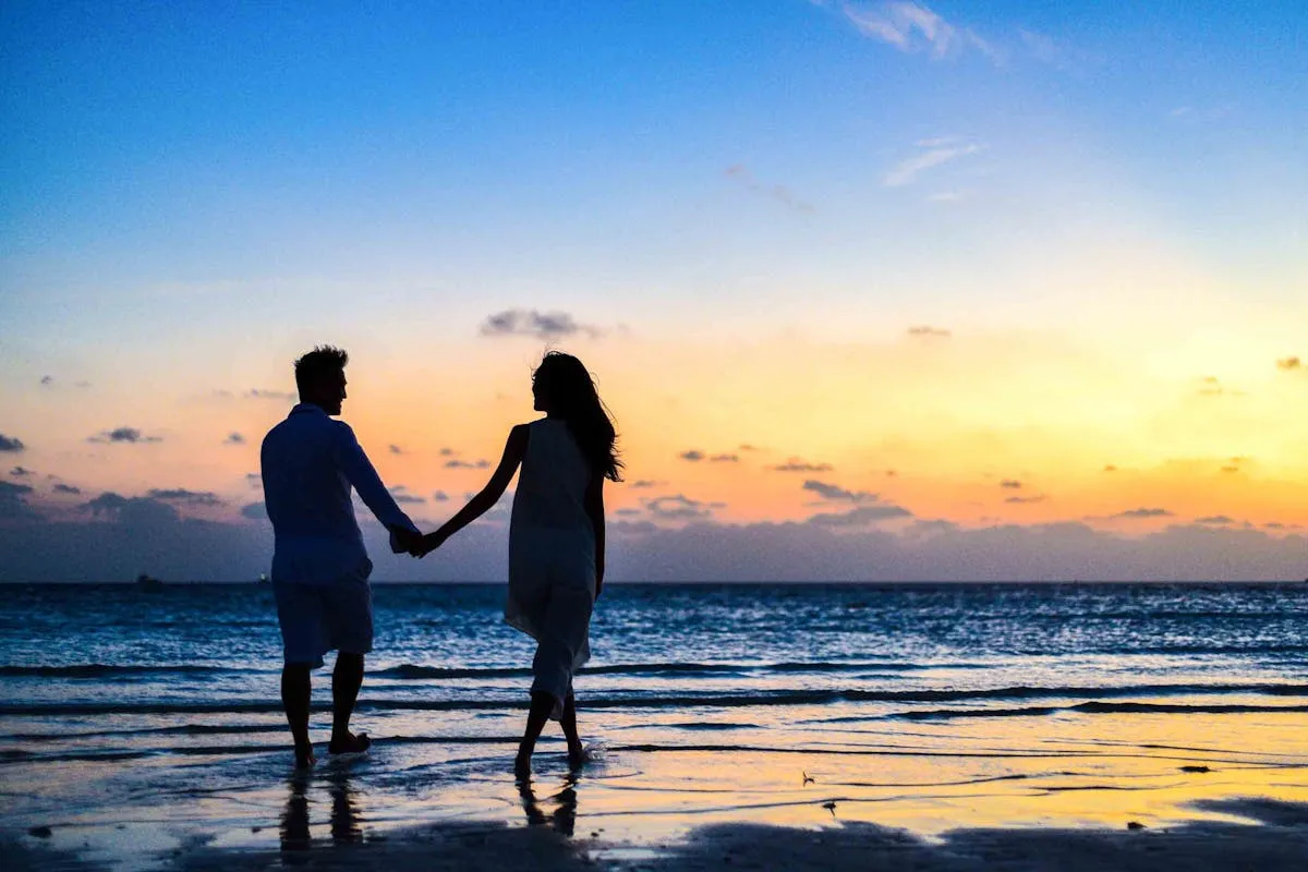 A couple on a tropical beach at sunset