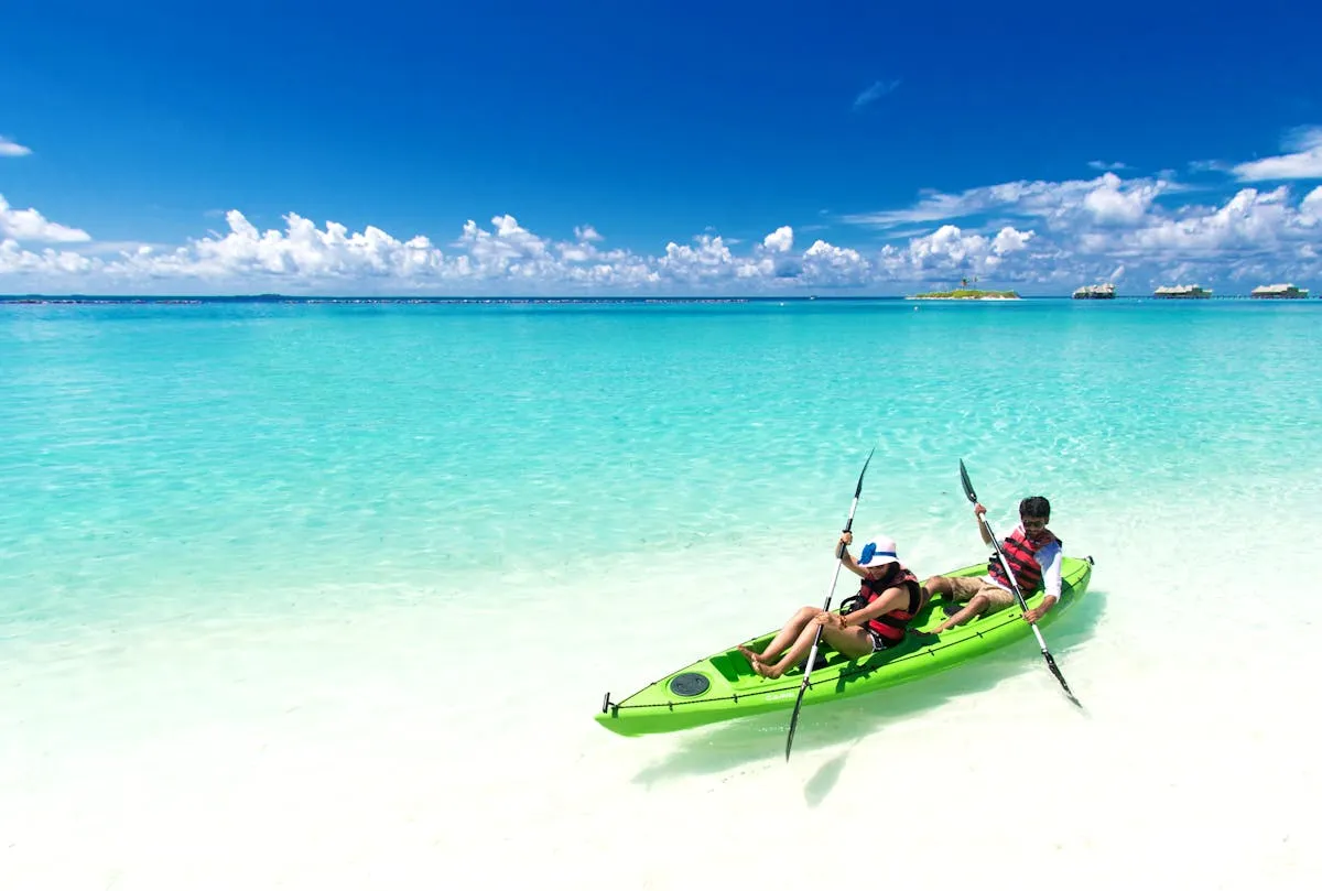 People in a kayak on clear tropical waters